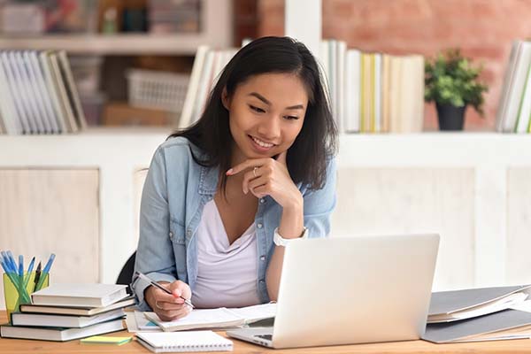 Teen learns about personal finance on her laptop